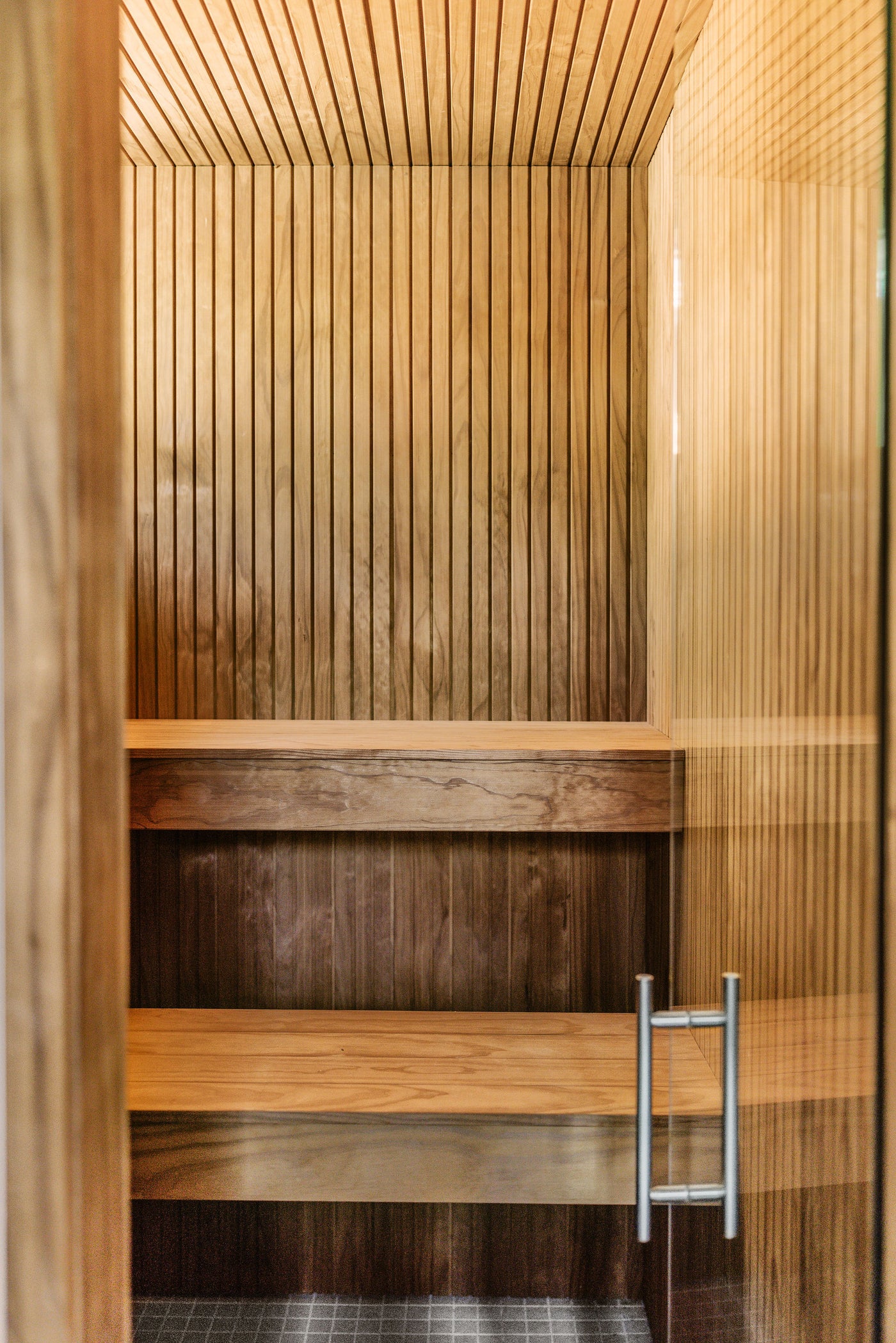 Thermowood sauna interior — slatted aspen walls and bench